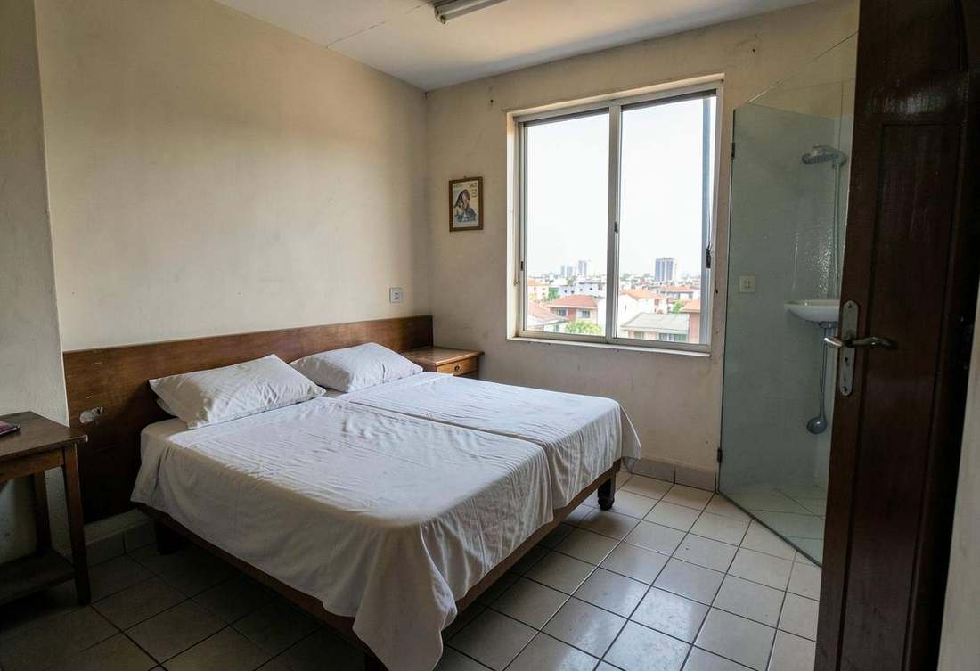 Tidy budget hotel room in Kigali with a city view