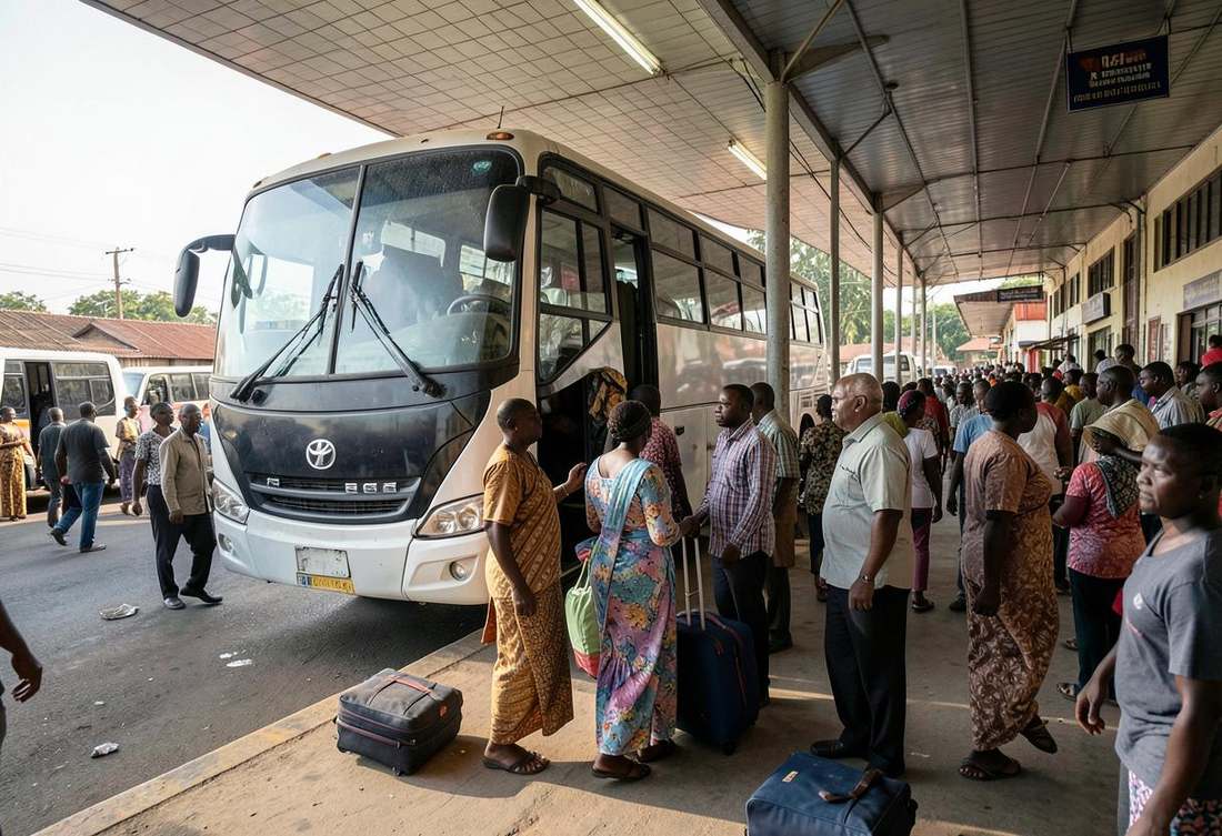 Passengers boarding an intercity coach with luggage at a Rwandan bus station