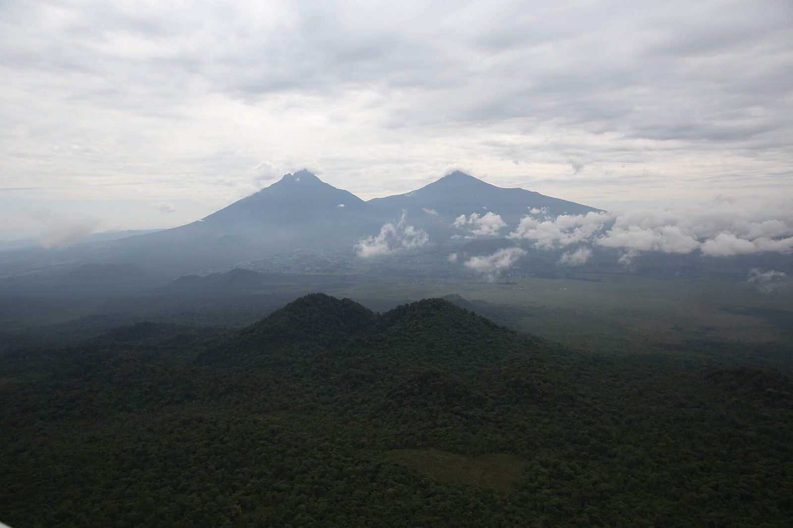 Mist lifting over the Virunga volcanoes on a northern Rwanda itinerary