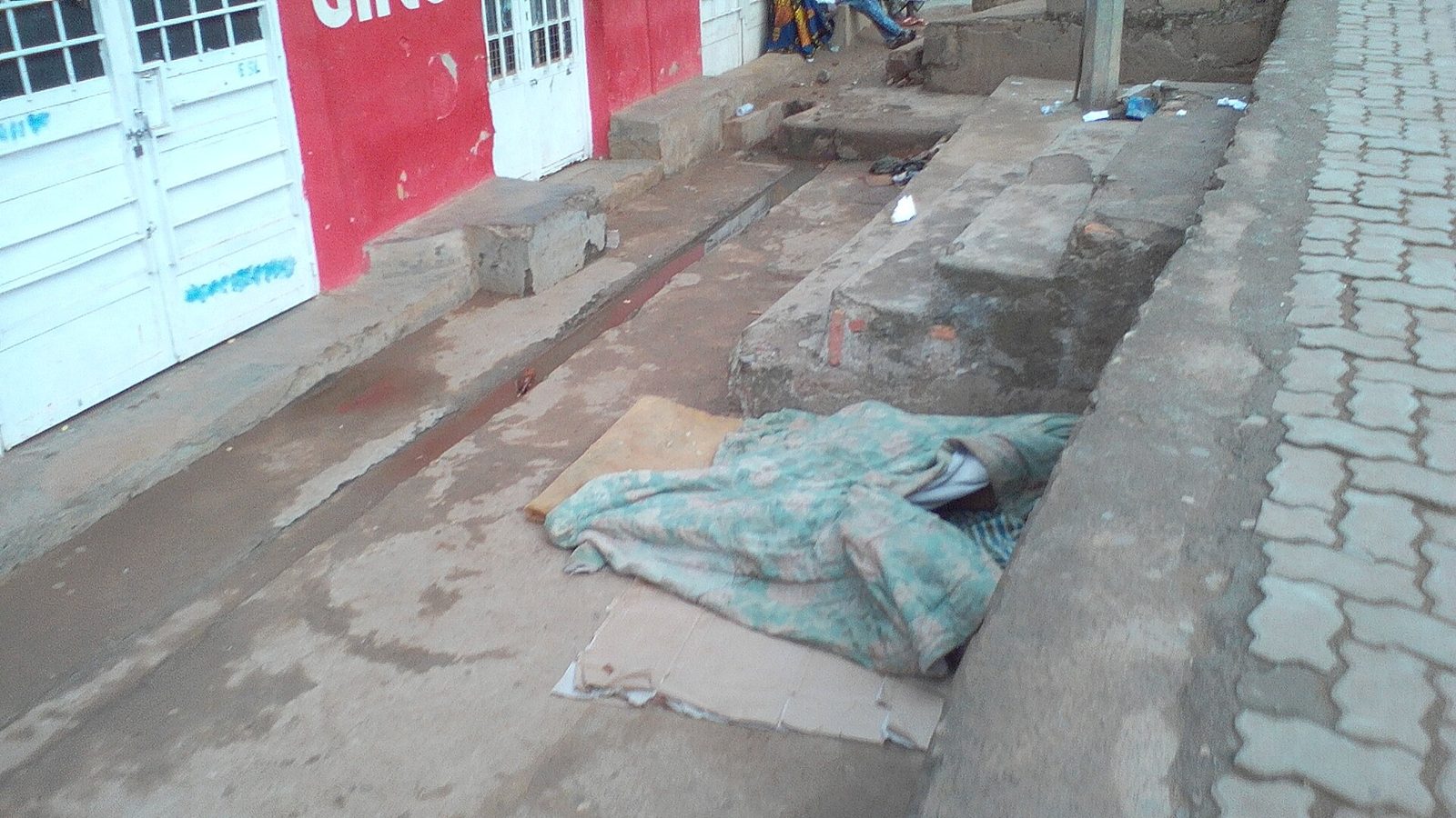 A busy Nyamirambo street lined with small shops and salons