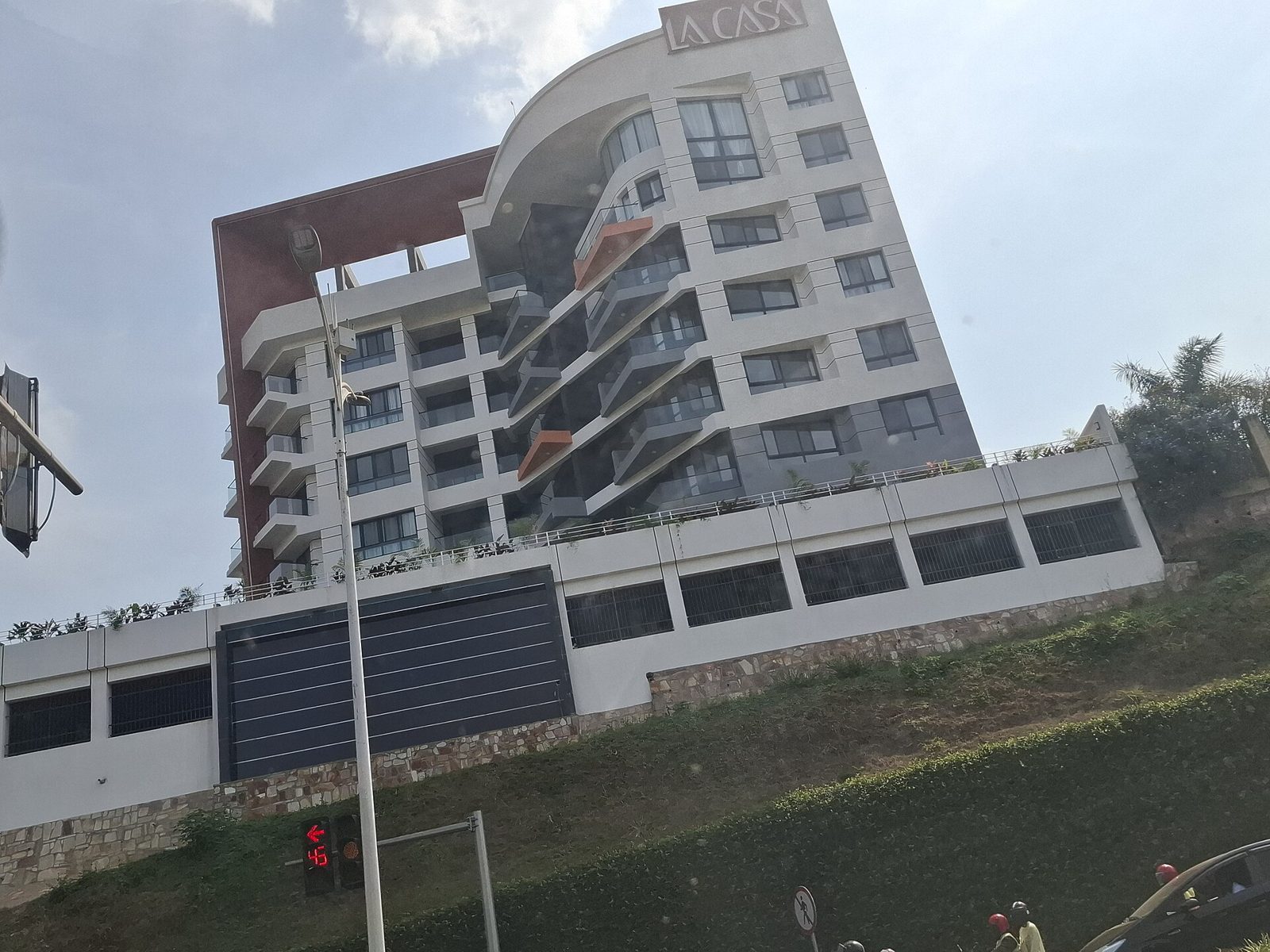 Business traveller working in a Kigali cafe with city views